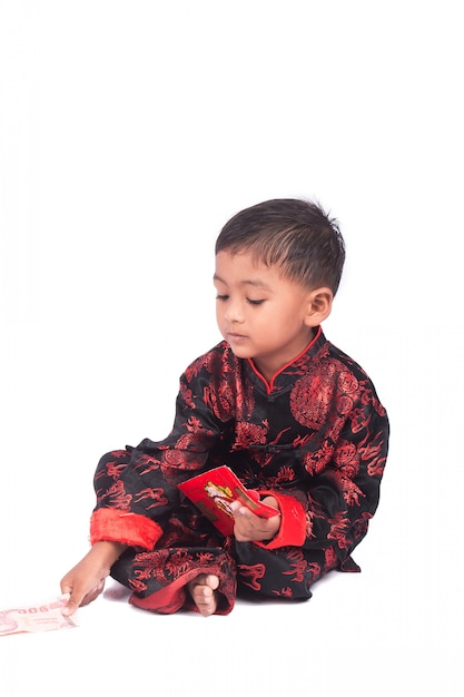 Happy chinese new year, asian little boy holding red envelope