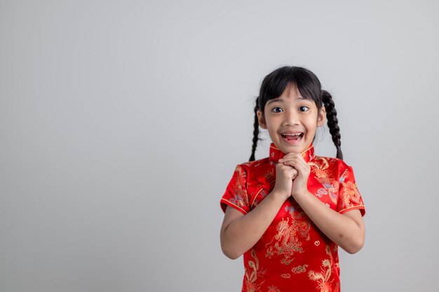 Happy Chinese new year. Little Asian girls with Congratulation gesture