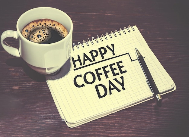 Happy coffee day on notepad with coffee and pen retro style