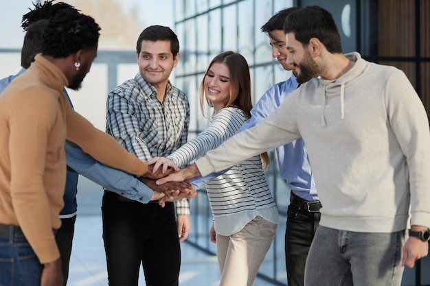 Happy colleagues welcome businessman to their successful team