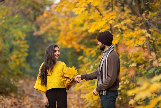 Happy couple in the autumn park Young family having fun outdoors