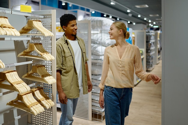 Happy couple buying household goods in store