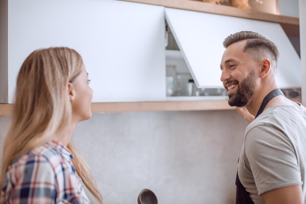 Happy couple discussing the menu standing in the kitchen