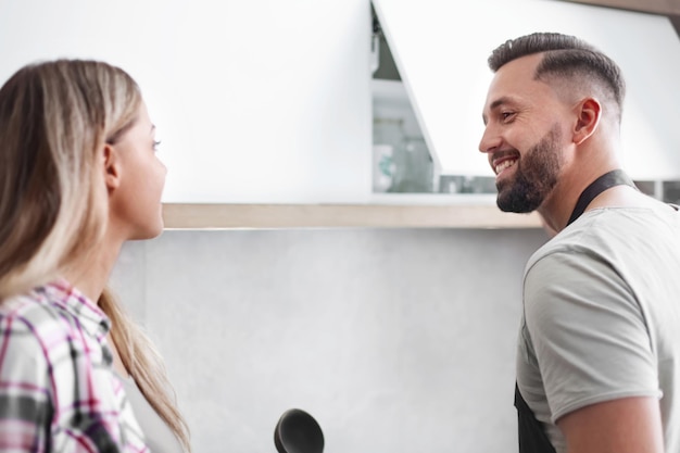 Happy couple discussing the menu standing in the kitchen