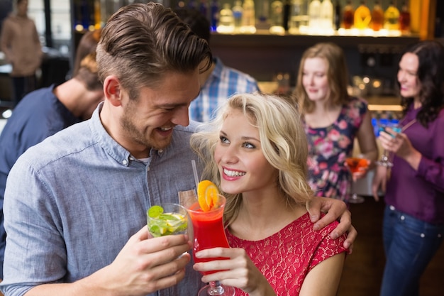 Happy couple drinking cocktails together