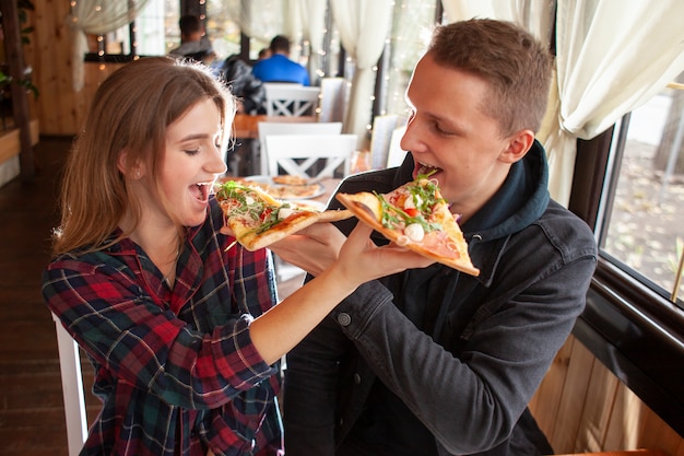 Happy couple eating pizza