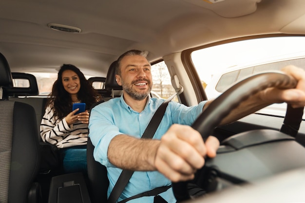 Happy couple enjoying drive on new car