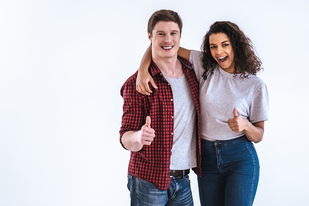 The happy couple gesturing on the white background