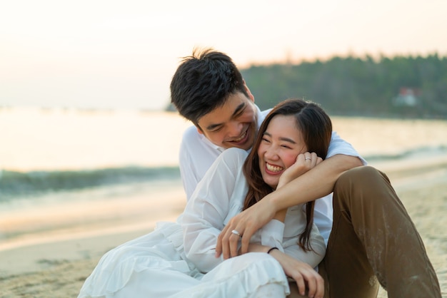 Happy couple going honeymoon travel on tropical sand beach in summer