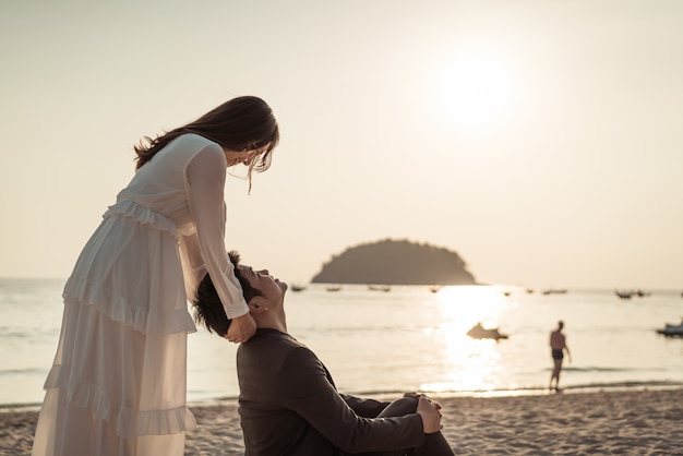 Happy couple going honeymoon travel on tropical sand beach in summer