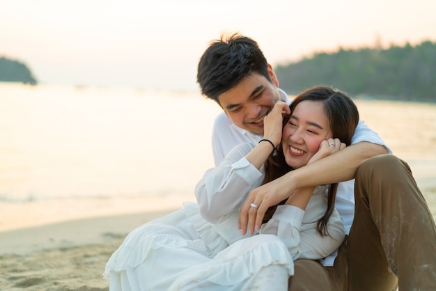 Happy couple going honeymoon travel on tropical sand beach in summer