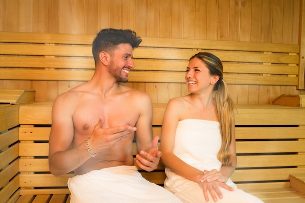 Happy couple having a steam bath in a sauna