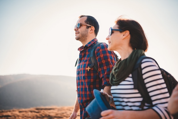 Happy couple hiking together on a mountain