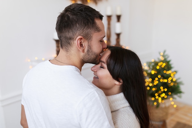 Happy couple at home on Christmas time