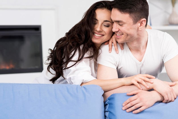 Happy couple at home on couch