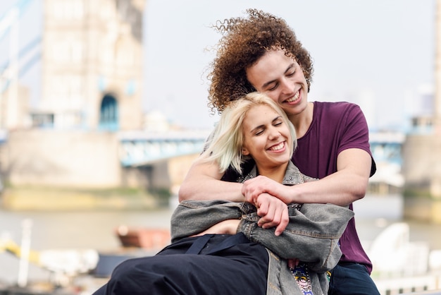 Happy couple hugging at the Tower Bridge