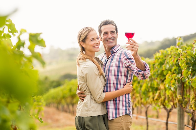 Happy couple looking at glass of wine