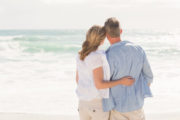 Happy couple looking out to sea