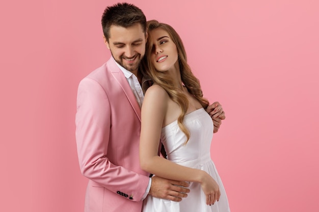 Happy couple in love embracing on pink background st valentines day