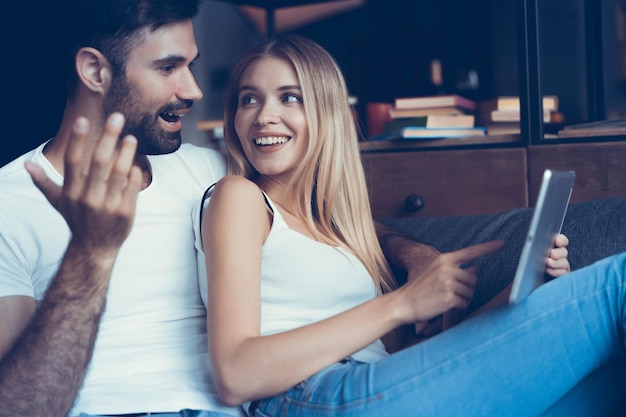 Happy couple in love surfing on tablet at home