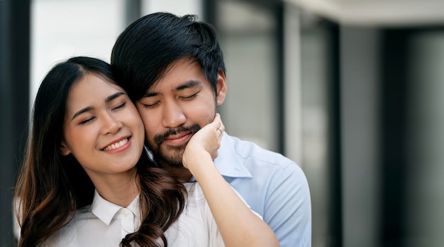 Happy couple or lover hugging with warming at home