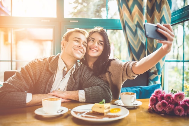 The happy couple making a selfie in a restaurant