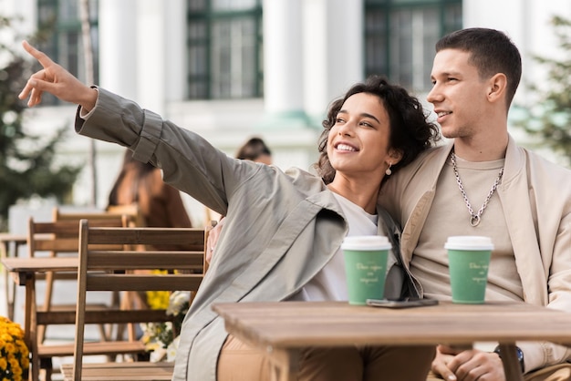 A happy couple outdoors near a cafe