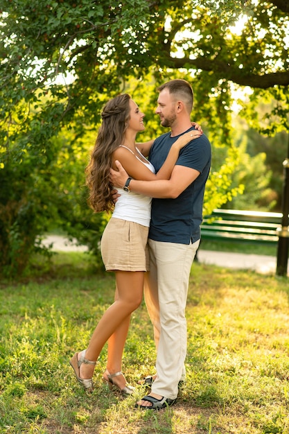 Happy couple on a picnic smiling at each other on a sunny day.People,love,happiness and nature concept