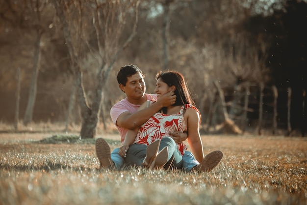 Happy couple posing in the field just married wedding couple