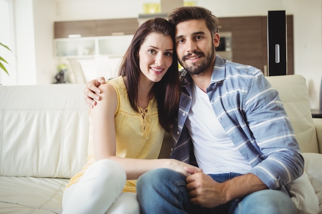 Happy couple relaxing on sofa