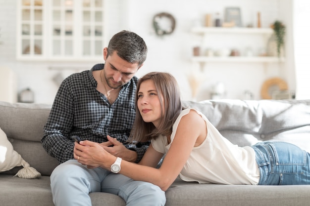 Happy couple spending time together in light living room