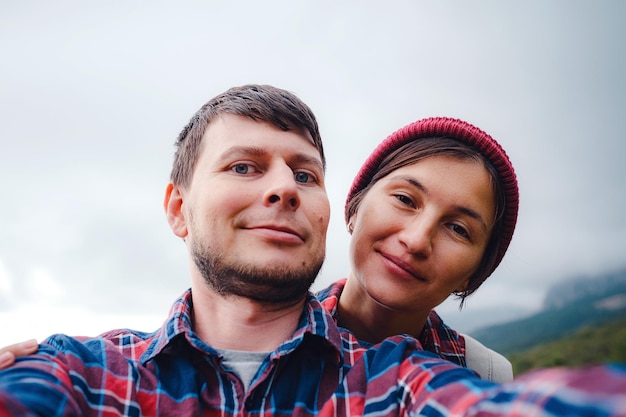 Happy couple taking selfie selfportrait photo hiking