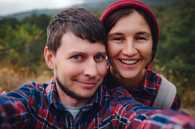 Happy couple taking selfie selfportrait photo hiking