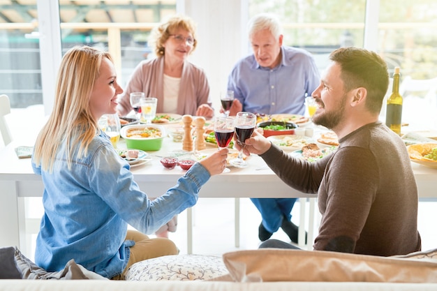 Happy Couple Toasting at Family Dinner