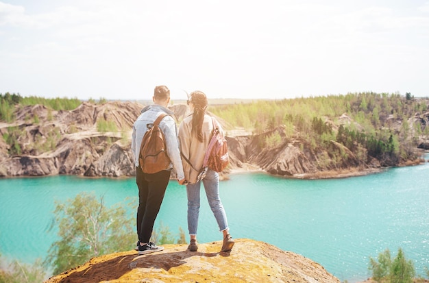 Happy couple at top of mountain enjoy the view of blue lake