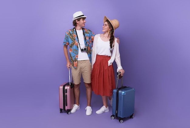 Happy couple tourist hugging together with baggage going to travel on holidays