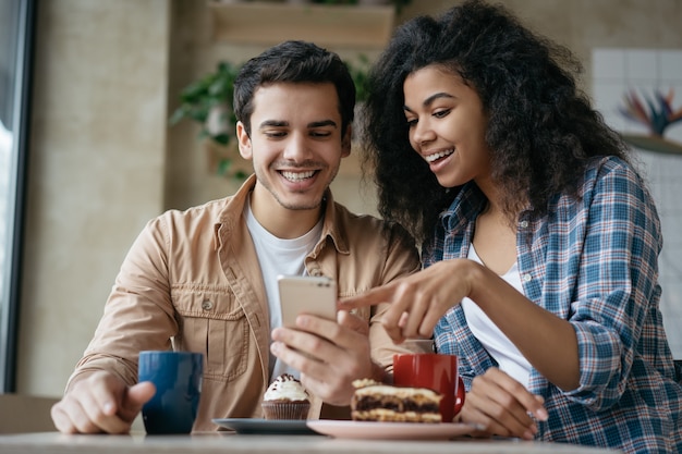 Happy couple using mobile phone shopping online