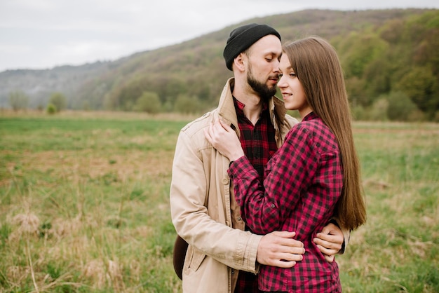 Happy couple walking on the nature at the mountains