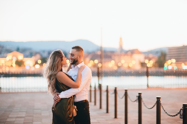 Happy couple walking in night city