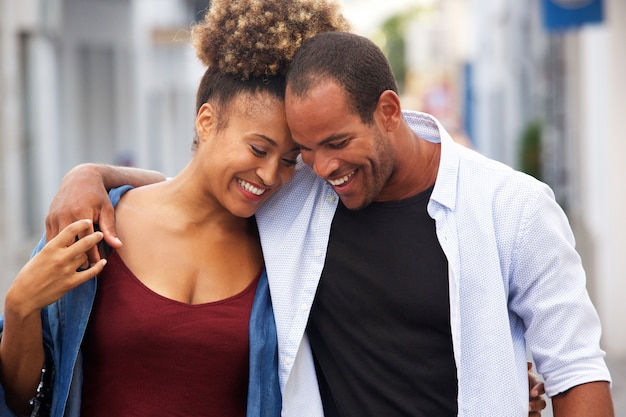 Happy couple walking together in embrace on date