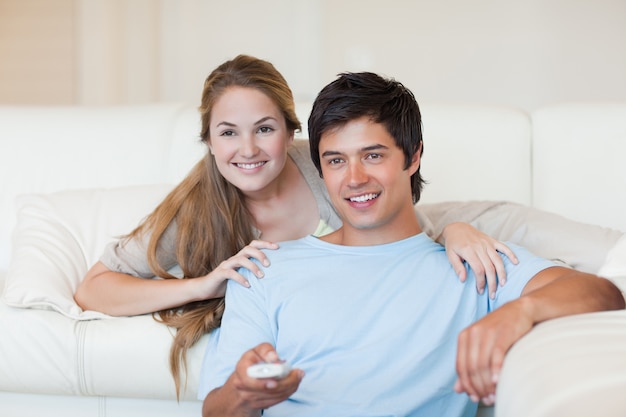 Happy couple watching television