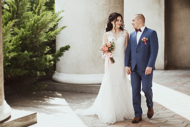 Happy couple on wedding day. Walk the bride and groom in the national park in autumn. Beautiful wedding.