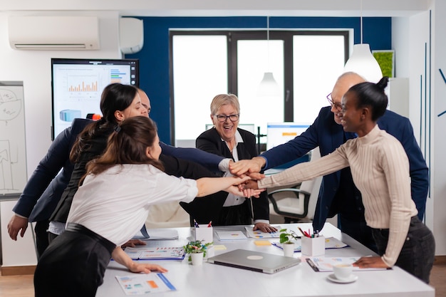 Happy creative multiethnic business team celebrating successful project