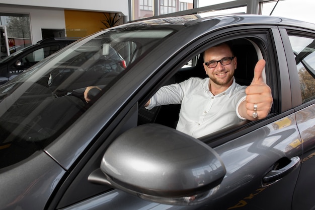 Happy customer in car dealership