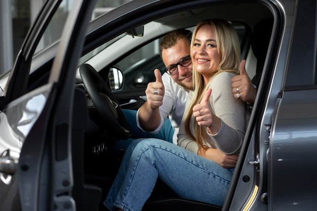 Happy customers in car dealership