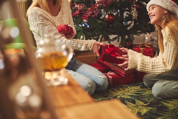 Happy cute girl getting gift from mom on Boxing Day