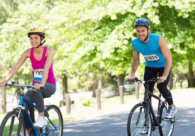 Happy cyclists riding bicycles 