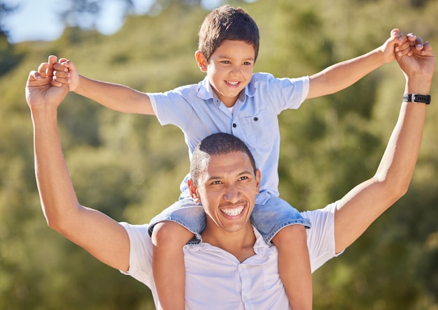 Happy dad child and family nature walk of a kid on father shoulders with a smile in the summer sun Happiness fun and outdoors experience of a man and kid walking and hiking in nature together