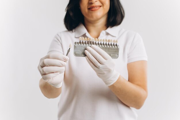 Happy dentist doctor woman showing mockup of implants