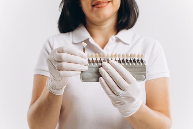 Happy dentist doctor woman showing mockup of implants